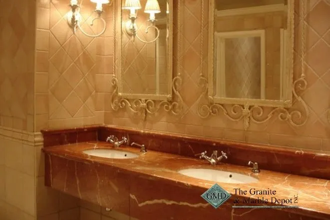 Deep red granite vanity top with an ornate tile backsplash