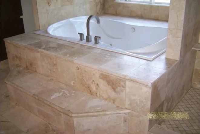 Travertine tub surround with stepped stone edges