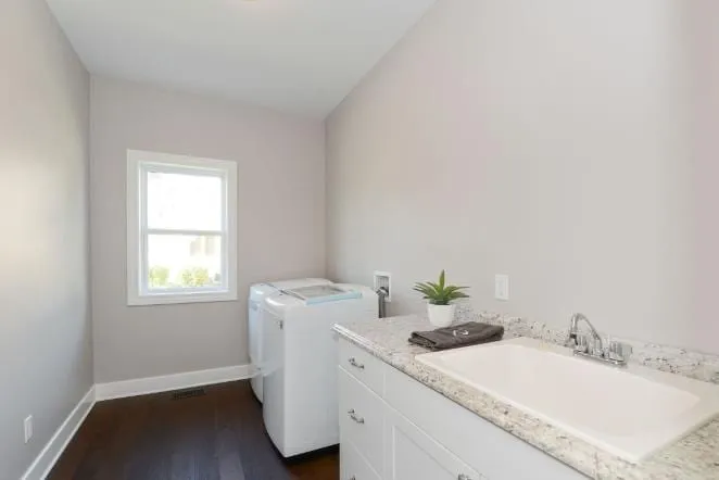 White vanity and tub in a bathroom under a sloped ceiling