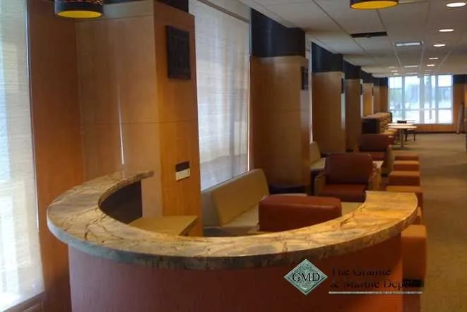 Curved reception desk topped with patterned granite
