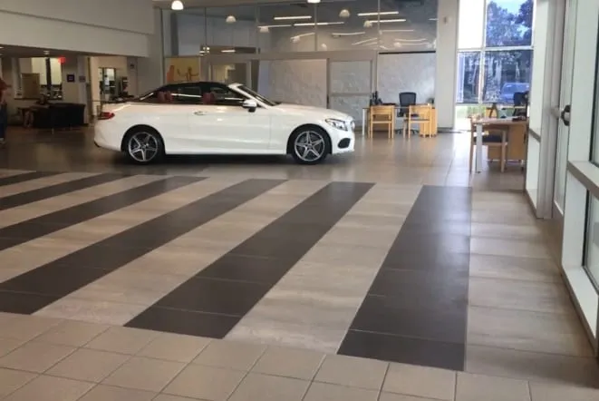 Dealership showroom with a striped stone tile floor