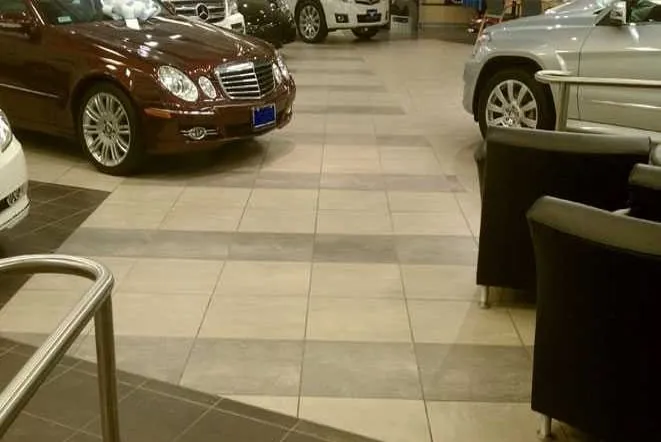 Car dealership showroom with a large-format tile floor