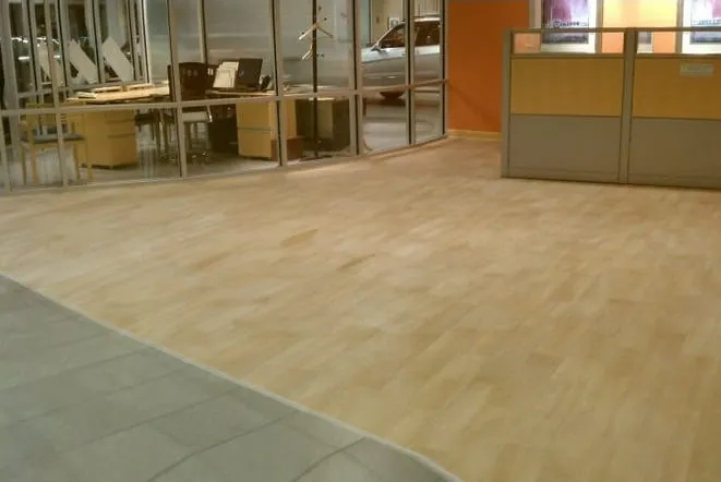 Office interior with a stone tile floor and glass partitions