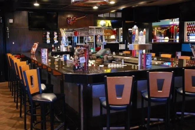 Restaurant bar with a polished granite top and bar stools
