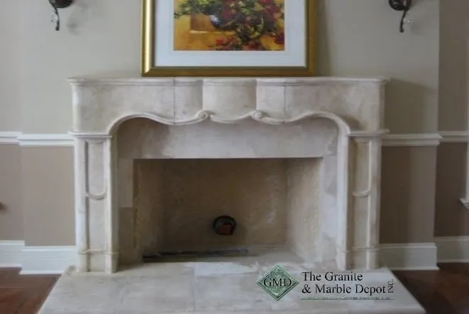 Carved cream stone fireplace mantel with an arched opening