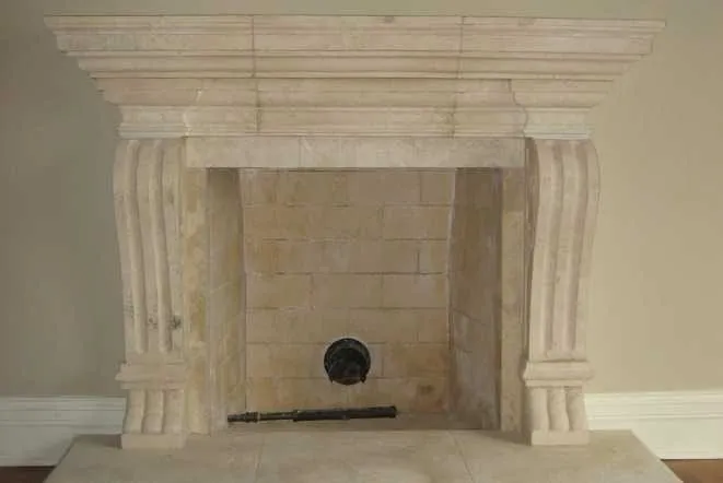Travertine fireplace mantel with column legs and a stone hearth