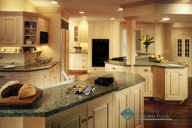 Open-plan kitchen with cream cabinets and dark granite countertops on two islands