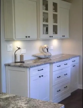 Grey and white granite counters on white shaker cabinets