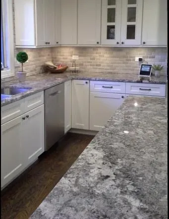 Grey granite peninsula in a white cabinet kitchen