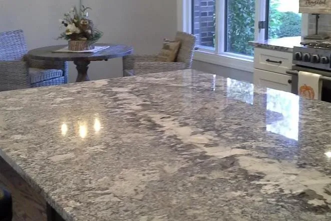 Close view of a polished grey and white granite island top