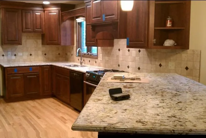 Cherry cabinets and light granite countertops over hardwood floors